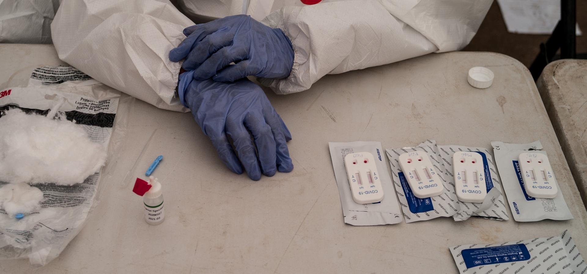 White coat, blue gloves, on a table with medicine 