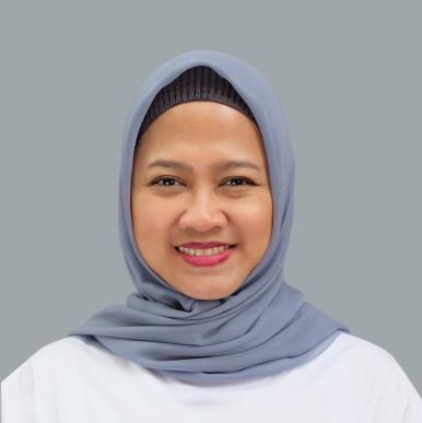 Indonesian woman wearing a gray-blue headscarf smiles into the camera