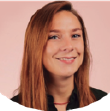 Woman with light brown hair smiles into the camera