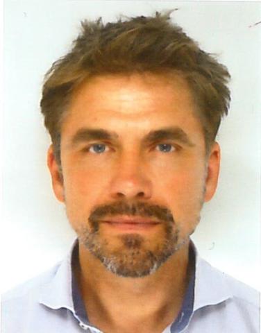 Headshot of a man in front of a white background