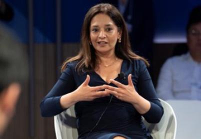 Priya Basu - Foreign Policy Q&A Priya Basu sits in a white chair, wearing a blue dress