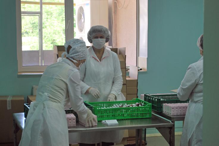 Private company employees pack pharmaceuticals. 