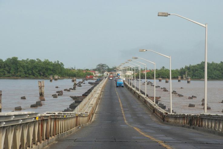 gray concrete bridge over river during daytime in Guyana