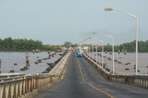 gray concrete bridge over river during daytime in Guyana