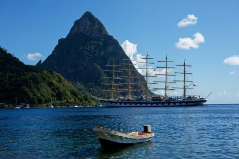 A tall ship in Sugar Bay St Lucia, mountain in background over bright blue water